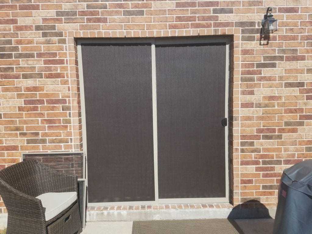 90% chocolate fabric with tan frame shaded patio door.