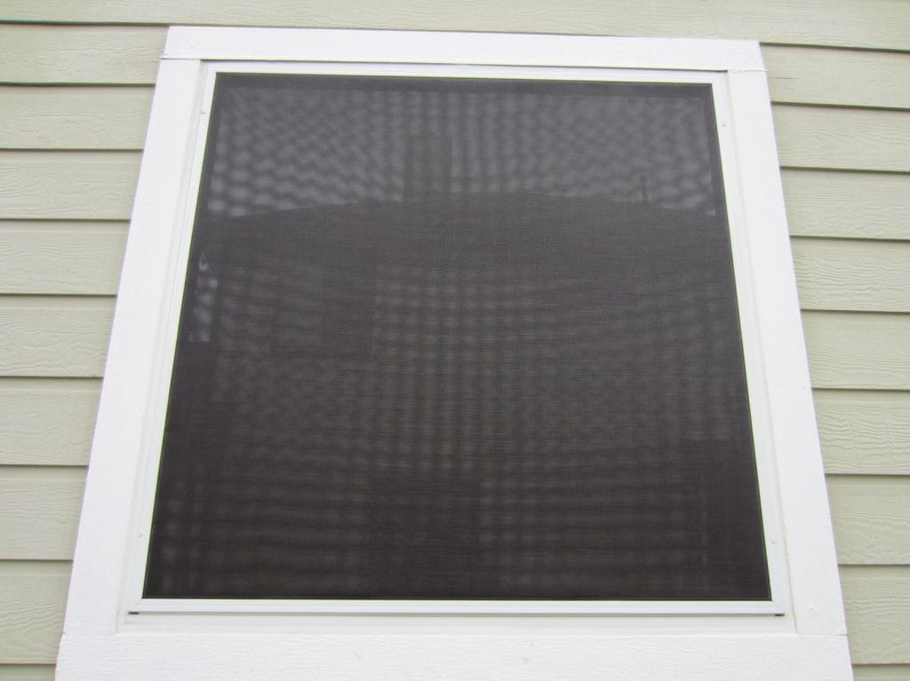 Showing a solar screen installed correctly by avoiding weep holes.