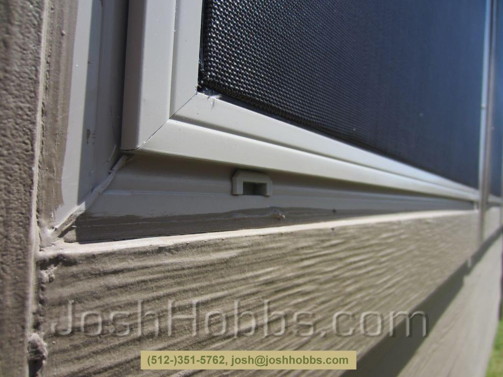 A solar screen properly installed correctly avoiding weep holes.