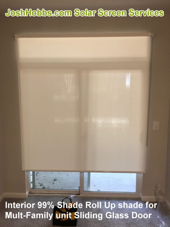 Showing a multi-family sliding glass door shaded from the inside with one of our roll up shades.