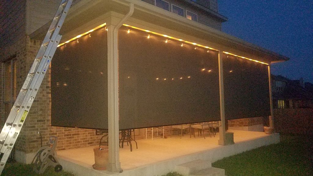 Patio roller shades during the evening.